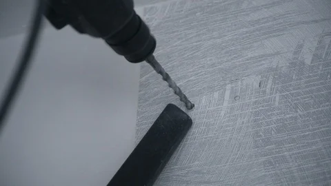 A Builder drills a hole in the wall Stock Footage 103948802