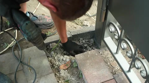 Builder Drills a hole in the wall with a Hammer Drill Stock Footage 258645517
