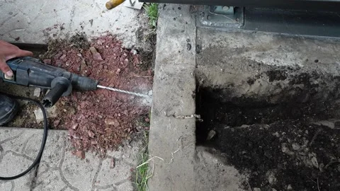 Builder Drills a hole in the wall with a Hammer Drill Stock Footage 258645727