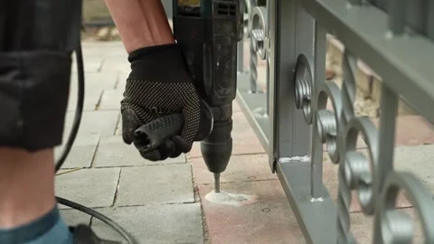 Builder Drills a hole in the wall with a Hammer Drill Stock Footage 258645998