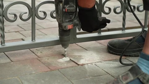 Builder Drills a hole in the wall with a Hammer Drill Stock Footage 258646000