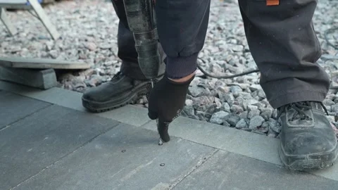 Builder Drills a hole in the wall with a Hammer Drill Stock Footage 259037407