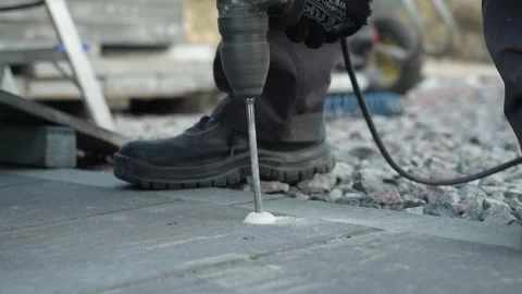 Builder Drills a hole in the wall with a Hammer Drill Stock Footage 259037431