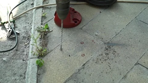 Builder Drills a hole in the wall with a Hammer Drill Stock Footage 259037602