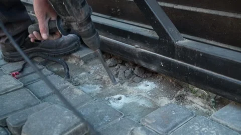Builder Drills a hole in the wall with a Hammer Drill Stock Footage 259037665