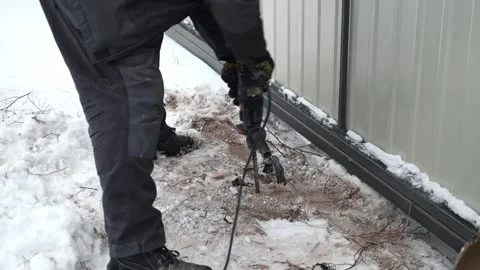 Builder Drills a hole in the wall with a Hammer Drill Stock Footage 263294788