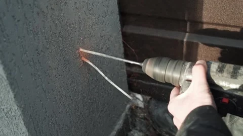 Builder Drills a hole in the wall with a Hammer Drill Stock Footage 263294798