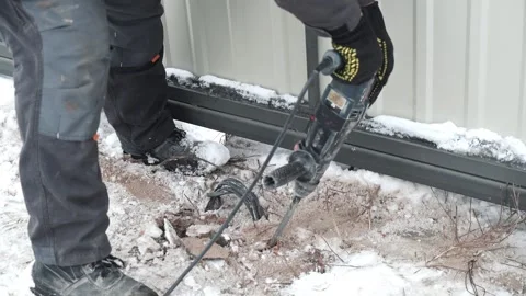 Builder Drills a hole in the wall with a Hammer Drill Stock Footage 263294822