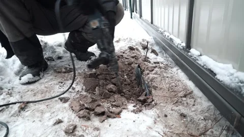 Builder Drills a hole in the wall with a Hammer Drill Stock Footage 263294835