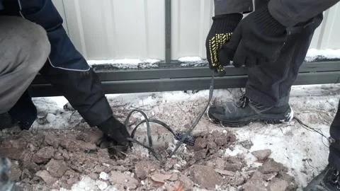 Builder Drills a hole in the wall with a Hammer Drill Stock Footage 263294857