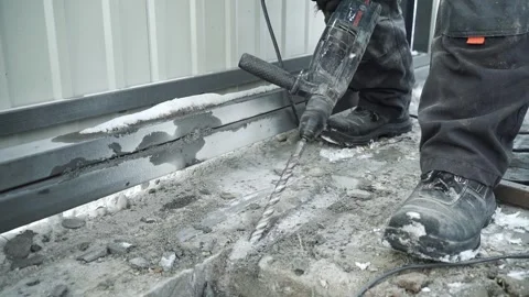 Builder Drills a hole in the wall with a Hammer Drill Stock Footage 263294905