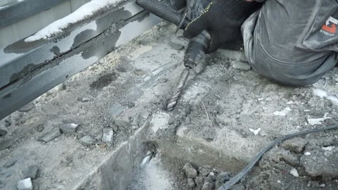 Builder Drills a hole in the wall with a Hammer Drill Stock Footage 263294911