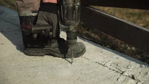 Builder Drills a hole in the wall with a Hammer Drill Stock Footage 269495279