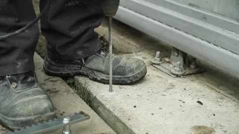 Builder Drills a hole in the wall with a Hammer Drill Stock Footage 269495296