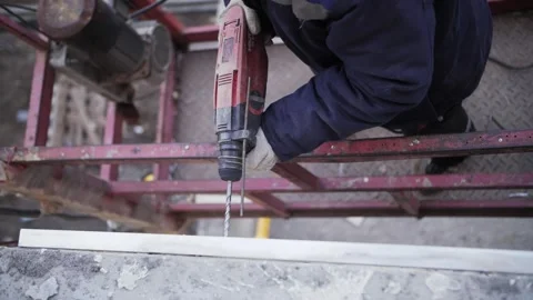 Builder drills the wall of the house, hands close-up Stock Footage 165820814