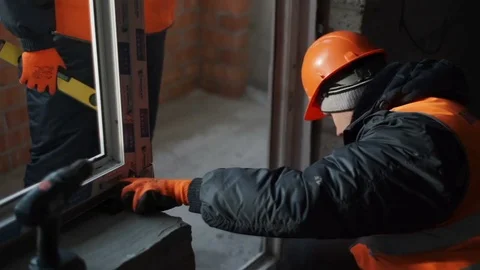 Builder drive in the screw into the concrete wall Stock Footage 82294672