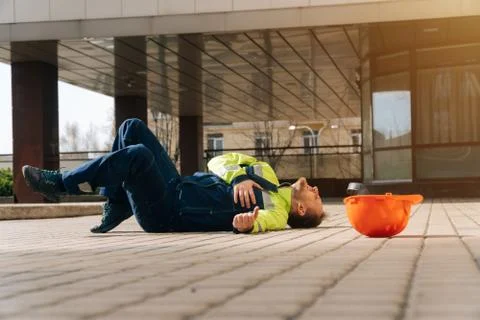 The builder during his work fell ill with his heart. Industrial accident conc Stock Photos