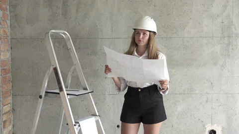 A builder engineer checks the blueprints in the apartment. Video stock 164904534