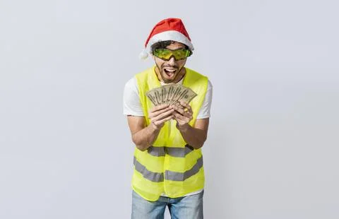 Builder engineer in christmas hat with happy expression holding dollars iso.. Stock Photos