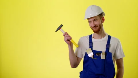 Builder, Engineer In Helmet And Blue Uniform And Pointing By Hammer On Copyspace Stock Footage 170187994