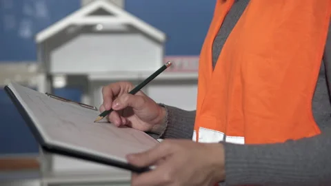 A builder engineer works with blueprints of a future house for a large family. Stock Footage 143322029