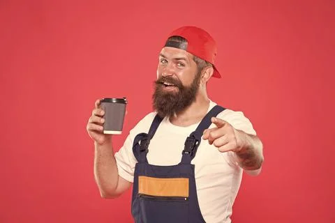 Builder enjoy coffee. Handsome builder hold coffee cup. Man protective uniform Stock Photos