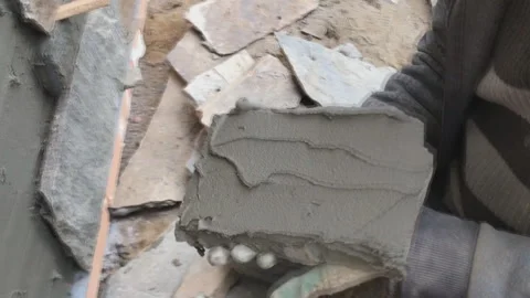 Builder faces the basement of a house with a wild stone. Flat for cladding Video stock 239266218