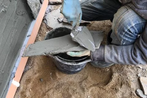 Builder faces the basement of a house with a wild stone. Flat for cladding,.. Stock Photos