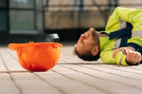 The builder fell from the construction site, broke his arm. industrial accide Stock Photos