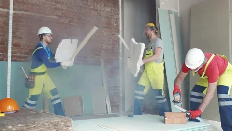 Builder fighting with construction tools and materials on work site Stock Footage