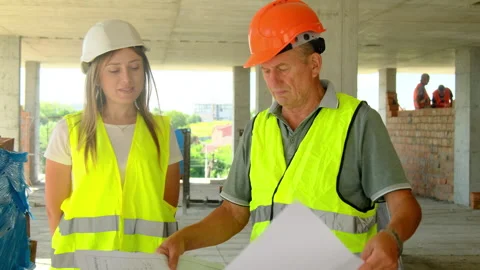 Builder finishes studying floor plan at construction site Stock Footage 317611940
