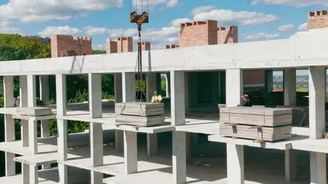 The builder fixed the load that will be lifted by the lifting crane Stock Footage 239536543