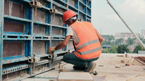 The builder fixes the metal structure on the construction site. Installation of Video stock 248224767