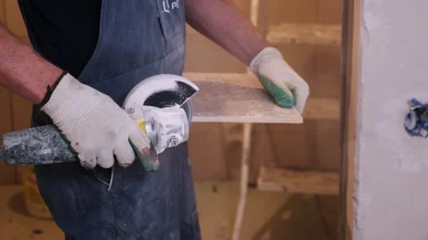 Builder Flattens Ceramic Tile with Spinning Blade. Construction Works. Repairs Stock Footage 145044861