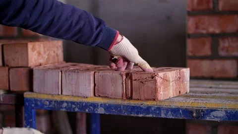 Builder folds bricks, construction site Stock Footage 221882378