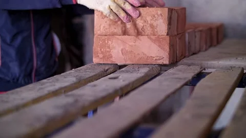 Builder folds bricks, hands close up Stock Footage 221957741