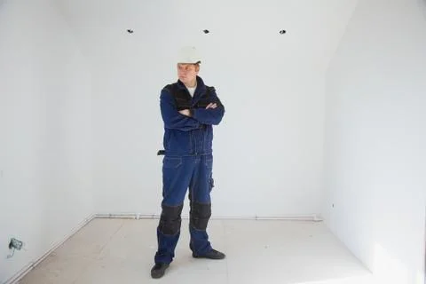 Builder foreman in a white helmet at a construction site indoors 写真素材