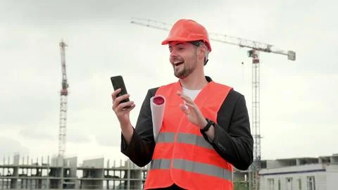 Builder with gadget working at construction site Foto stock