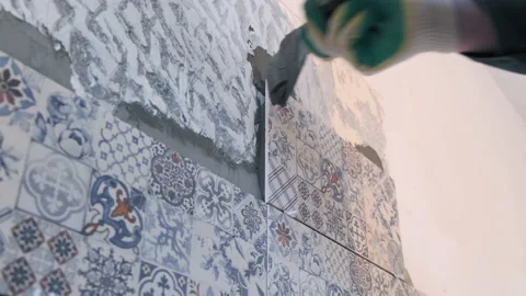 The builder glues the tiles to the wall Stock Footage 160487765