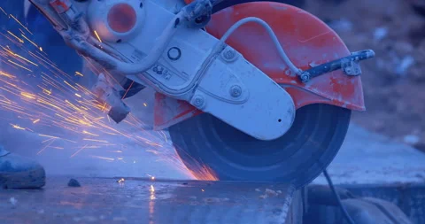 A builder by grinder cuts off part of a thick slab, a lot of sparks and smoke Stock Footage 147617694