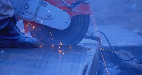 A builder by grinder cuts off part of a thick slab, a lot of sparks and smoke Stock Footage 147619046