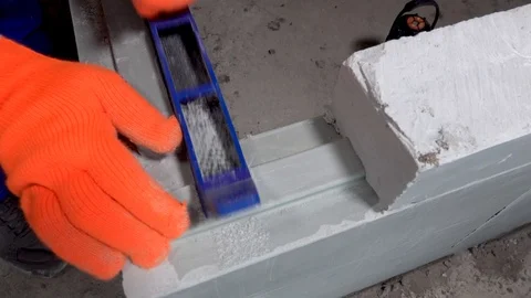 Builder grinds a plasterboard block with a planer, apartment or home repair Stock Footage 115418835