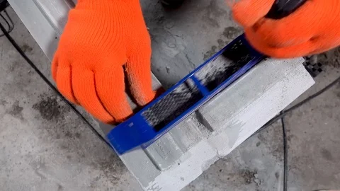 Builder grinds a plasterboard block with a planer, apartment or home repair Stock Footage 115418889