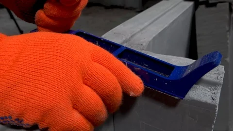 Builder grinds a plasterboard block with a planer, apartment or home repair Stock Footage 115419049
