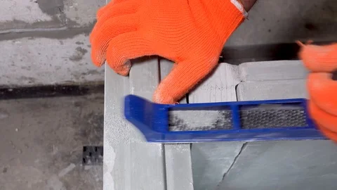 Builder grinds a plasterboard block with a planer, apartment or home repair Stock Footage 115419827