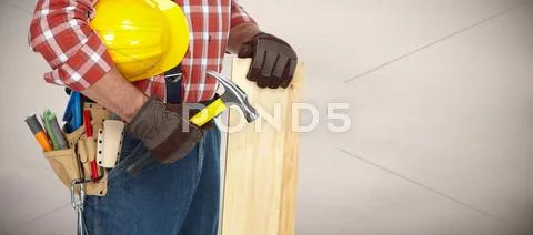 Builder with hammer and wooden planks. Stock Photos