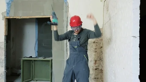 Builder with a hammer in the hands of dancing Stock Footage 112007999