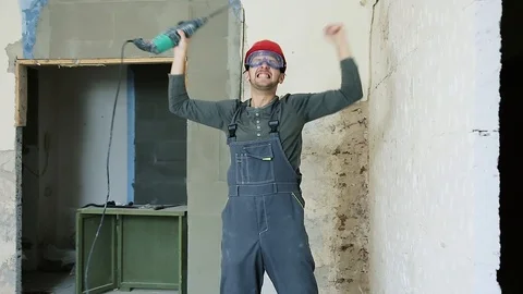 Builder with a hammer in the hands of the victorious shakes the punch Stock Footage 112008008