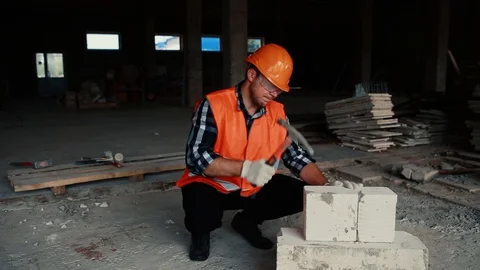 The builder is hammering on the cobblestone. Stock Footage 129195949