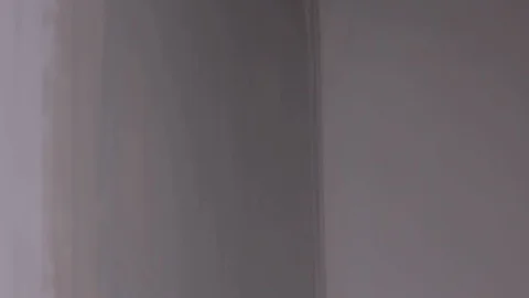 The Builder Hand Strikes The Primer On The Plaster Wall Stock Footage 101388755